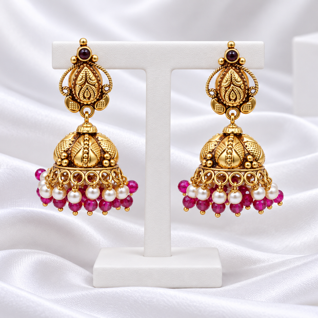 Antique Gold Tone Jhumka Earrings with Pink Beads & Pearl-Look Drops