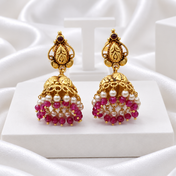 Antique Gold Tone Jhumka Earrings with Pink Beads & Pearl-Look Drops