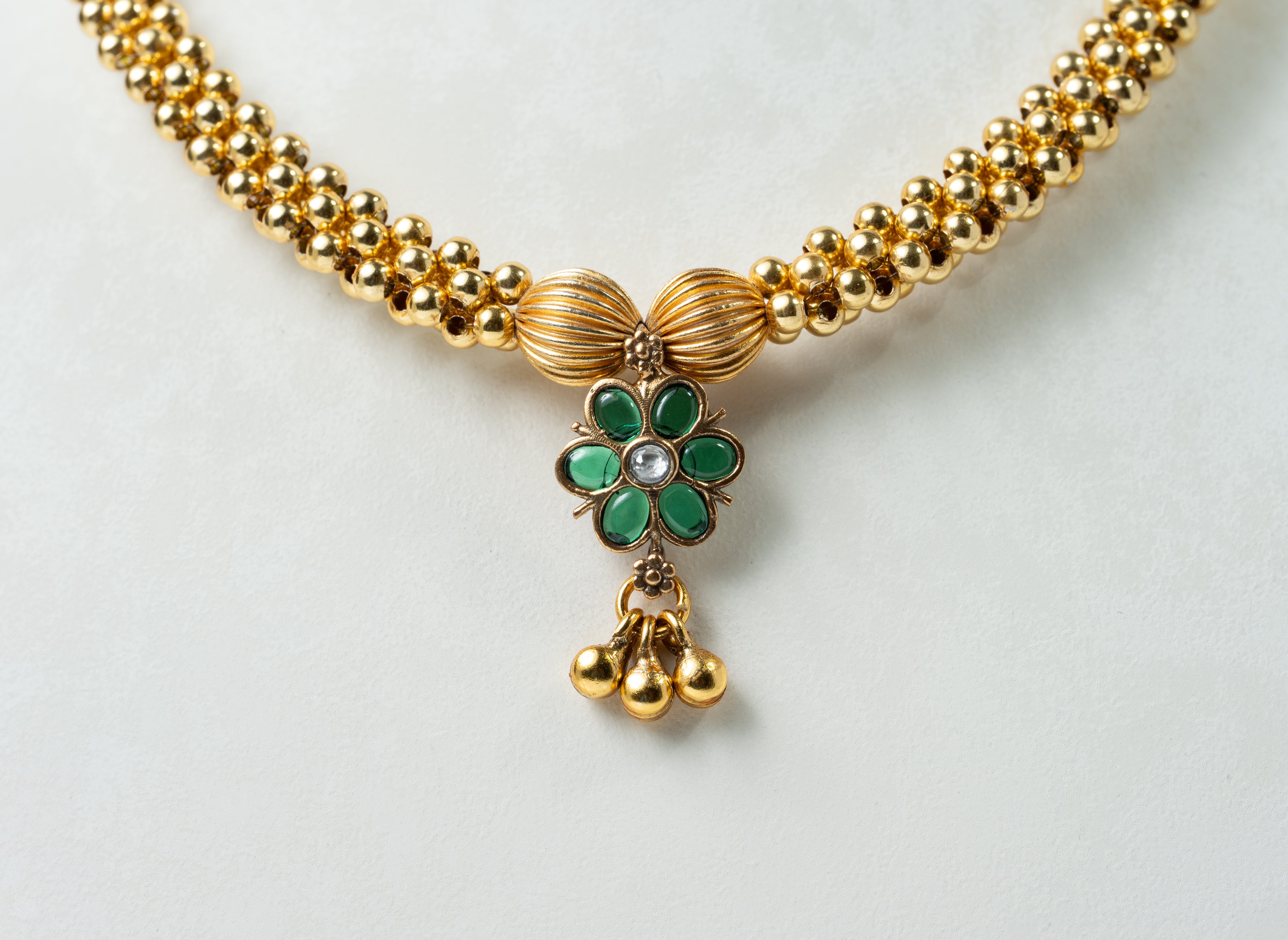 Traditional Gold-Tone Beaded Necklace with Green Floral Pendant