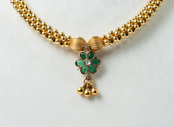 Traditional Gold-Tone Beaded Necklace with Green Floral Pendant
