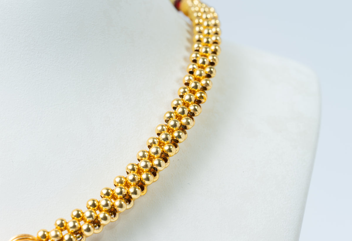 Traditional Gold-Tone Beaded Necklace with Green Floral Pendant