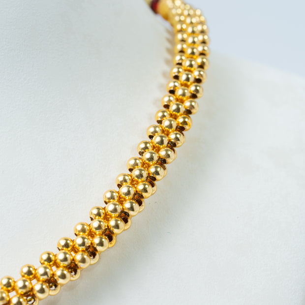 Traditional Gold-Tone Beaded Necklace with Green Floral Pendant