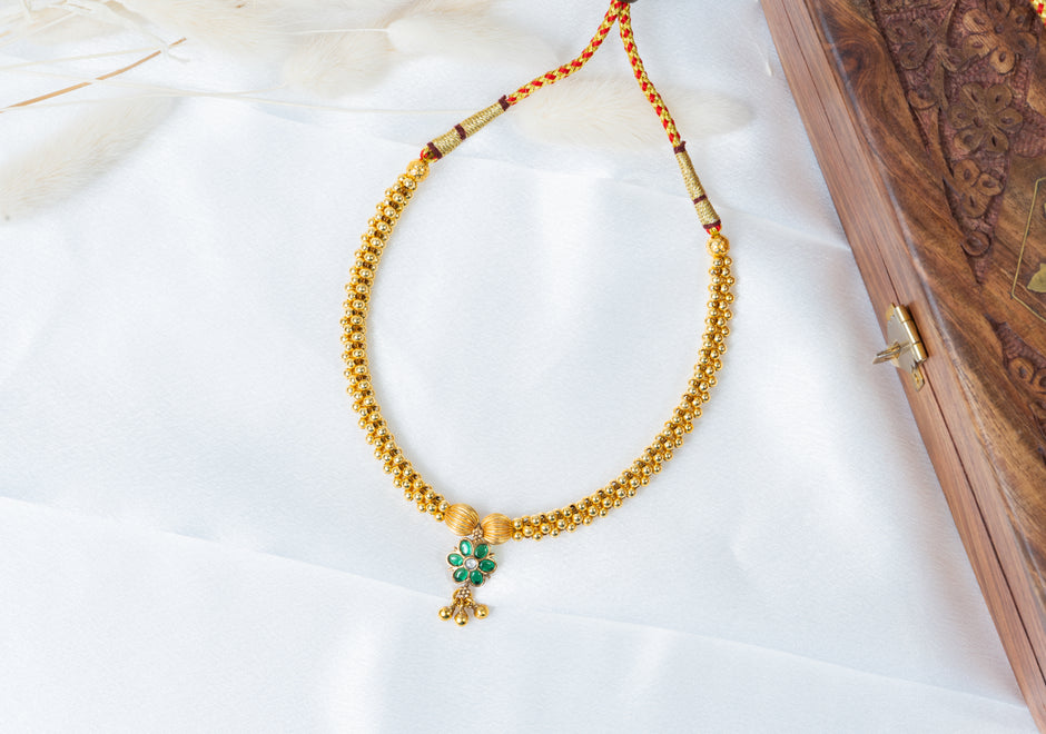 Traditional Gold-Tone Beaded Necklace with Green Floral Pendant