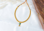 Traditional Gold-Tone Beaded Necklace with Green Floral Pendant